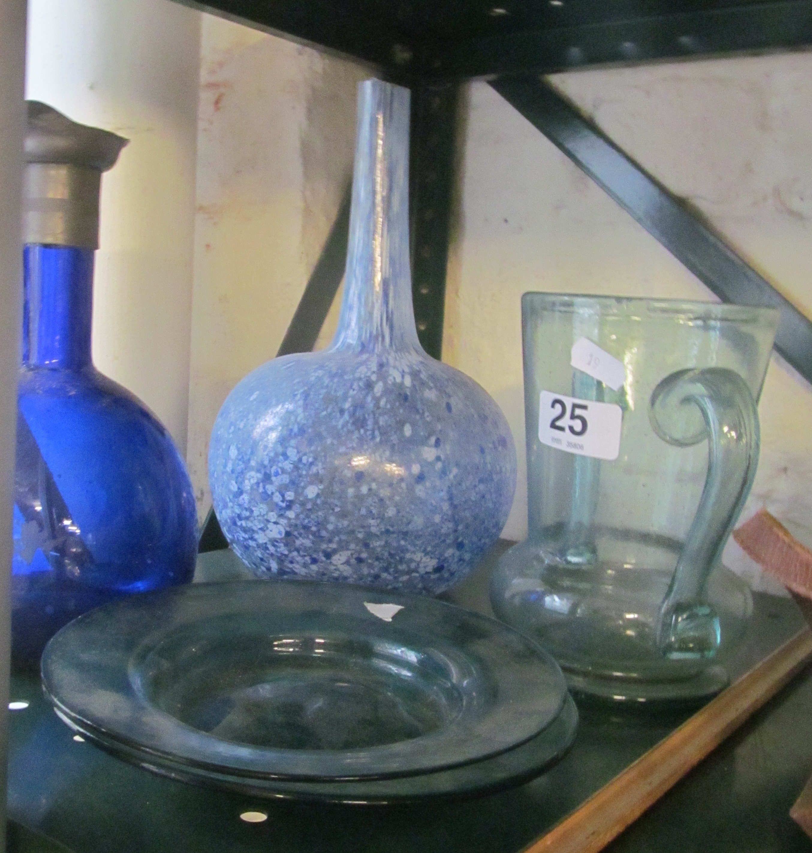 A blue mottled decanter, blue decanter, two ladles, vase and two plates.