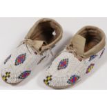 A PAIR OF BEADED PLAINS MOCCASINS, 20TH C