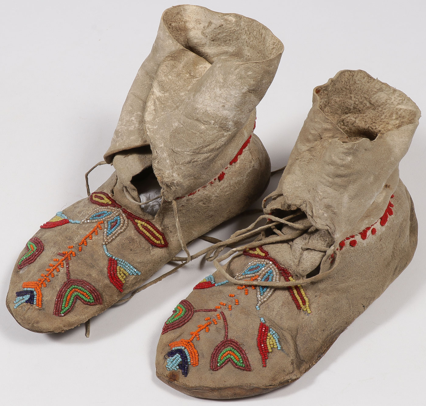 A PAIR OF PLAINS BEADED MOCCASINS, CIRCA 1900