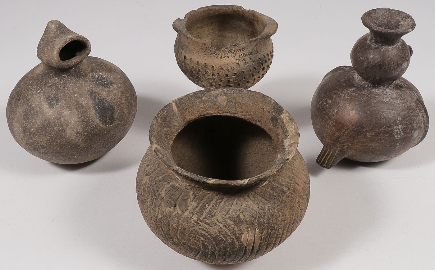 A COLLECTION OF FOUR POTTERY VESSELS