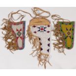 THREE BEADED HIDE HOLSTERS