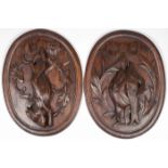 A PAIR OF CARVED OAK GAME PLAQUES, 19TH C