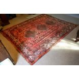 A North West Persian Woollen Carpet With Three Central Medallions within an all over design upon a