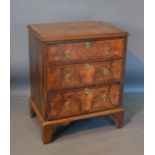 An 18th Century Style Walnut Chest, the cross banded top above three drawers with brass drop handles