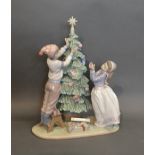 A Lladro Large Group, The Christmas Tree, 32cm tall