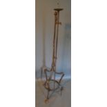 A 17th Century Style Wrought Iron Adjustable Lamp Standard With Shaped Legs