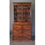 A Regency Mahogany Secretaire Bookcase, the moulded cornice above two astragal glazed doors