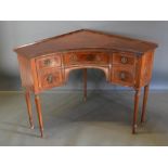 An Edwardian Mahogany Corner Wash Stand with an arrangement of drawers and cupboards, raised upon