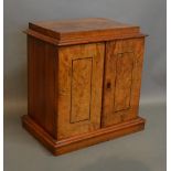 A Victorian Burr Walnut Table Cabinet With Two Line Inlaid Doors enclosing three drawers with sunken