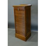 An Early 20th Century Oak Filing Cabinet, the tambour front enclosing various sliding trays, 50cm