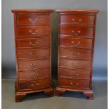 A Pair Of Reproduction Mahogany Tall Narrow Chests, the moulded tops above seven drawers with