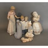 A Lladro Porcelain Model Of A Boy With Sheep, together with two other Lladro porcelain models and