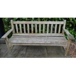 A Teak Garden Bench With Slated Back And Seat, raised upon square legs with stretchers, 159cm wide