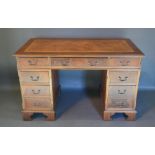 A Reproduction Mahogany Twin Pedestal Desk, the tooled leather inset top above nine drawers,