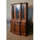 A 19th Century Walnut Miniature Break Front Bookcase, the moulded cornice above three glazed doors