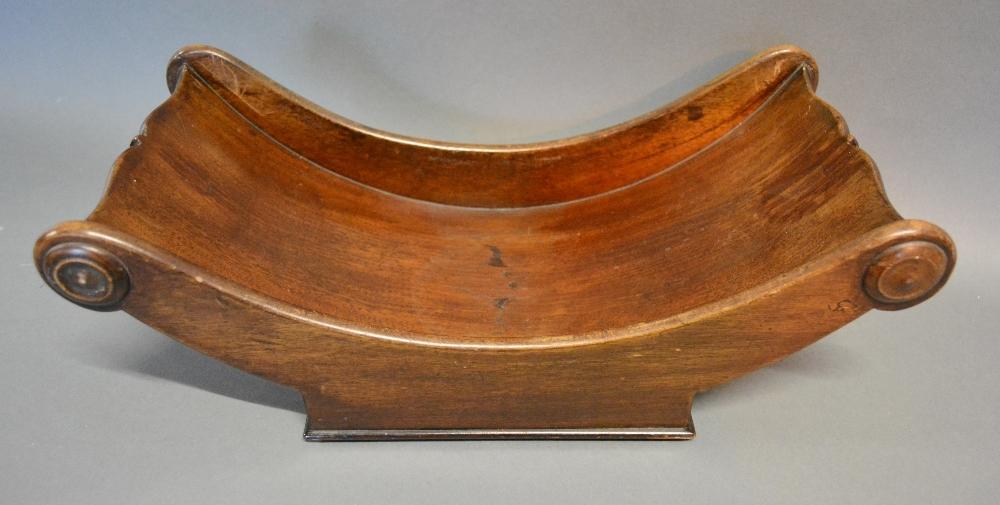 A Regency Mahogany Cheese Coaster Of Shaped Form with turned roundels, 38cm long