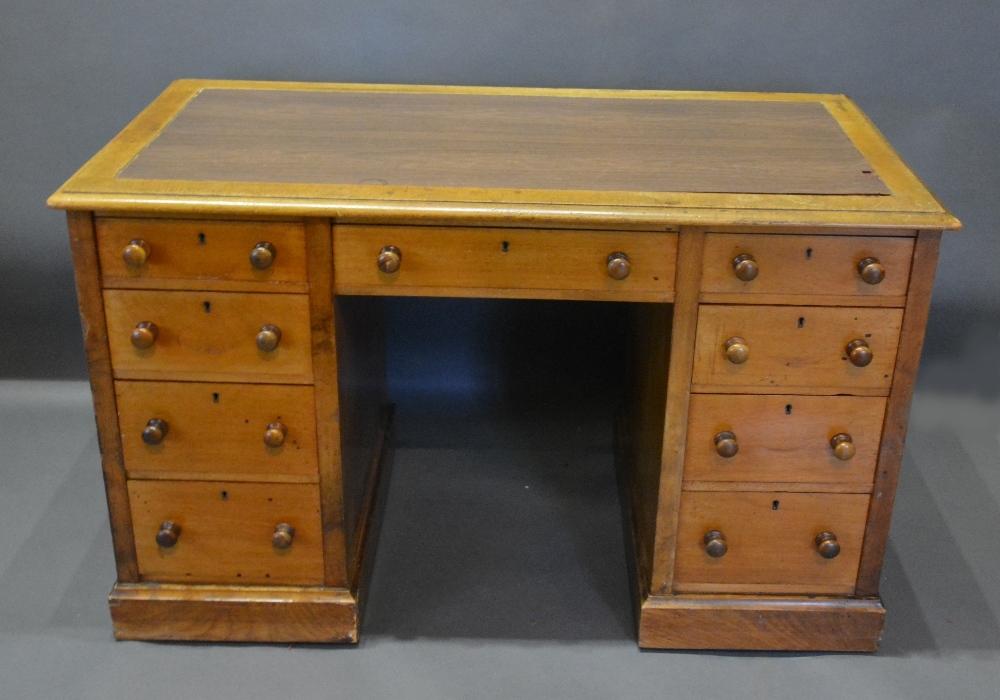 A Victorian Mahogany Twin Pedestal Desk, the moulded top above nine drawers with knob handles,