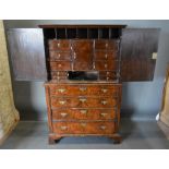 An 18th Century Walnut Cabinet On Chest, the moulded cornice above two herringbone inlaid doors