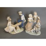 A Lladro Porcelain Group, The Seesaw, together with another similar Lladro group