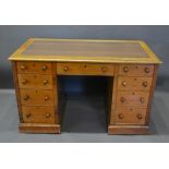 A Victorian Mahogany Twin Pedestal Desk, the moulded top above nine drawers with knob handles,