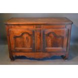 A Late 18th Early 19th Century French Oak Side Cabinet, the plank top above two shaped doors with