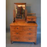 An Arts & Crafts Oak Dressing Table, The Swing Mirror with jewel drawer, above two short and two