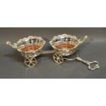 A Silver Plated Bottle Coaster Carriage Mounted With Putti, 50cm long