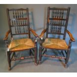 A Pair Of Early 19th Century Lancashire Spindle Back Armchairs with rush seats, raised upon turned