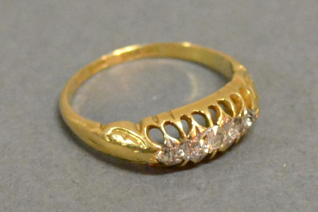 An 18ct. Yellow Gold Five Stone Diamond Ring with five graduated stones within a pierced setting