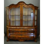 A Dutch Marquetry Bombe Bookcase The Shaped Cornice above two glazed doors enclosing shelves, the
