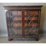 An Early 20th Century Mahogany Dwarf Bookcase, the moulded top above two astragal glazed doors