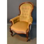 A Victorian Mahogany Spoonback Drawing Room Armchair, the button upholstered back above a stuff over