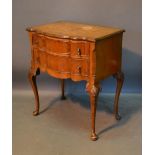 An Early 20th Century Queen Anne Style Walnut Serpentine Side Table, the moulded top above two