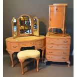 An Early 20th Century Burr Maple Bedroom Suite, comprising an oval dressing table, a matching four