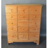 A Pine Collectors' Chest of Fifteen Drawers with Brass Knob Handles, 86 cms wide, 35 cms deep, 103