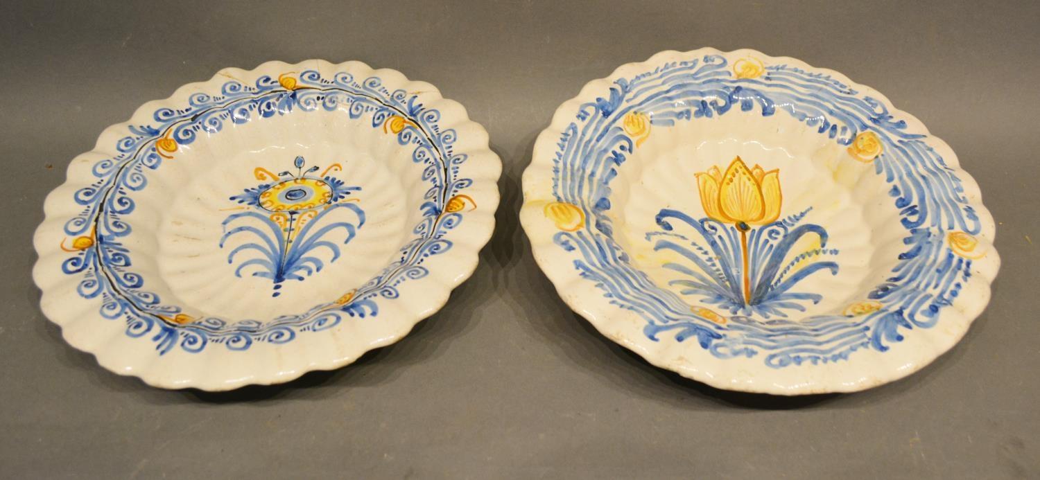 A 17th Century Delft Polychrome Decorated Dish, 30 cms diameter, together with another similar, 30