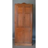 A 19th Century Oak Standing Corner Cabinet, the moulded top above four panel doors enclosing