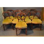 A Set Of Nine Victorian Mahogany Balloon Back Dining Chairs, each with a pierced rail back above