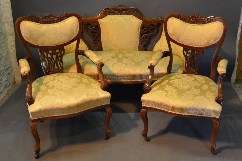 A Victorian Walnut Three Piece Drawing Room Suite, comprising sofa with two matching armchairs,