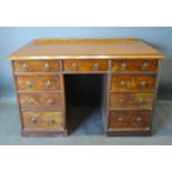 A 19th Century Mahogany Twin Pedestal Desk, the moulded top above nine drawers with brass handles,