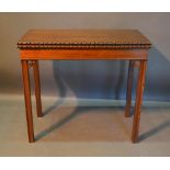 An Early 20th Century Mahogany Rectangular Card Table in the Chippendale style, the hinge top