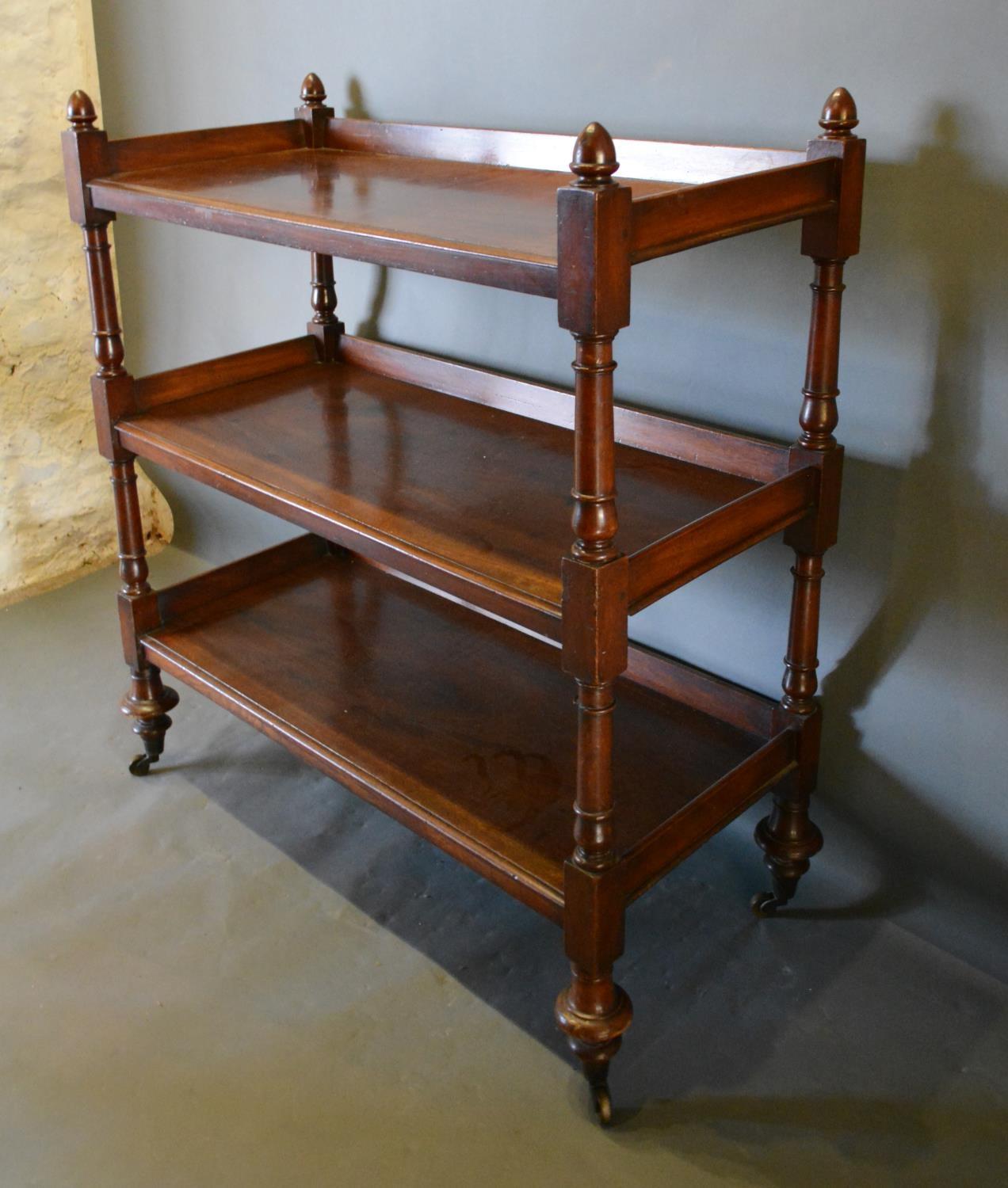 A Victorian Mahogany Buffet with a Low Galleried Back raised upon turned supports with brass caps