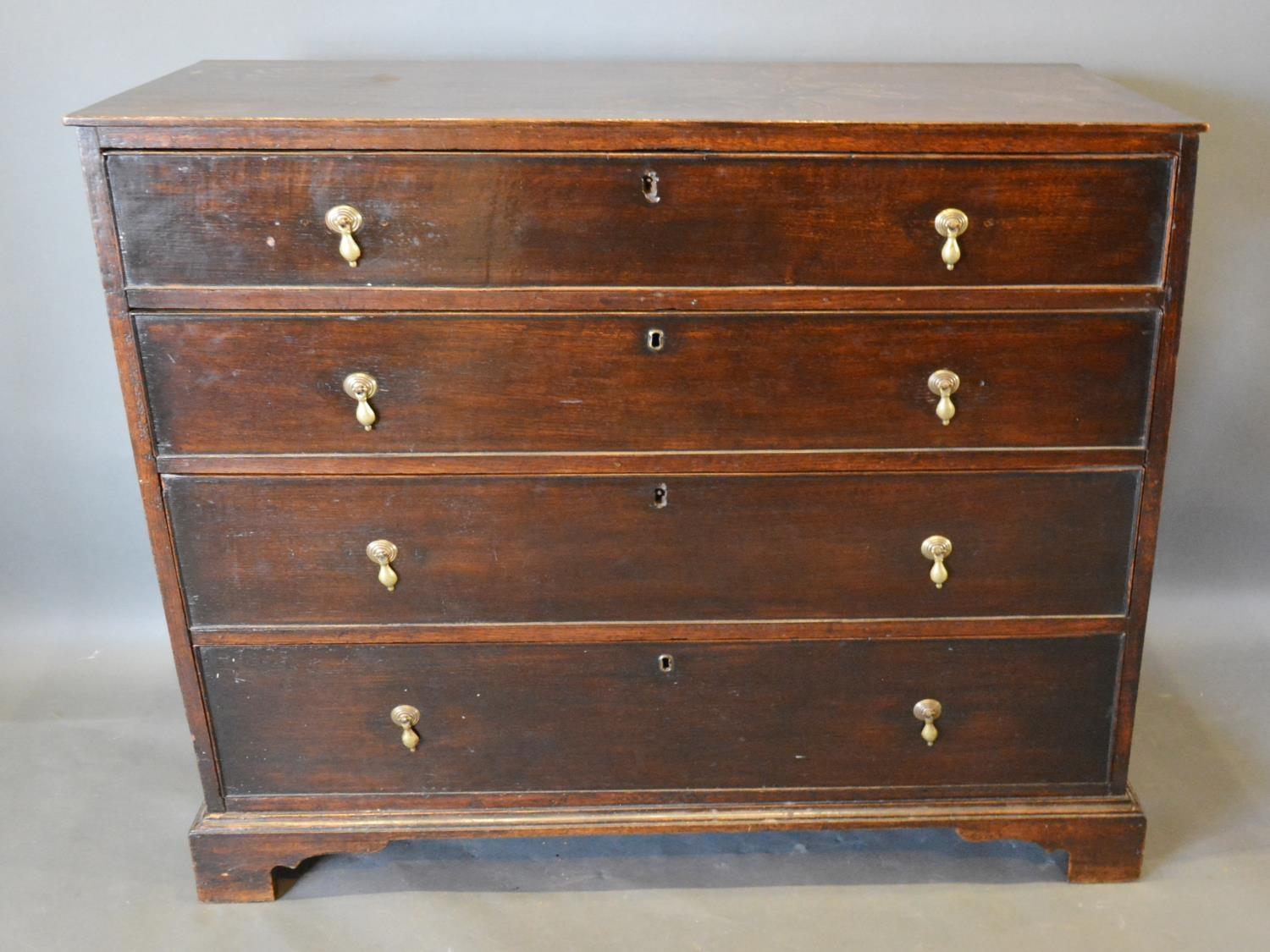 A 19th Century Oak Chest of Four Long Drawers with Brass Drop Handles, raised upon bracket feet, 100