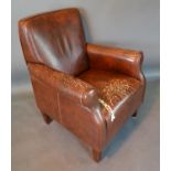 A Beige Leather Style Armchair With Square Tapering Legs