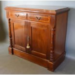 A Victorian Mahogany Side Cabinet, the moulded top above two inlaid drawers and two cupboard doors