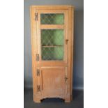 A 19th Century Pine Standing Corner Cabinet with a Lead Glazed Door above a Panel Door, raised