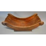 A Regency Mahogany Cheese Coaster Of Shaped Form with turned roundels, 38cm long