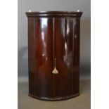 A George III Mahogany Bow Fronted Hanging Corner Cabinet