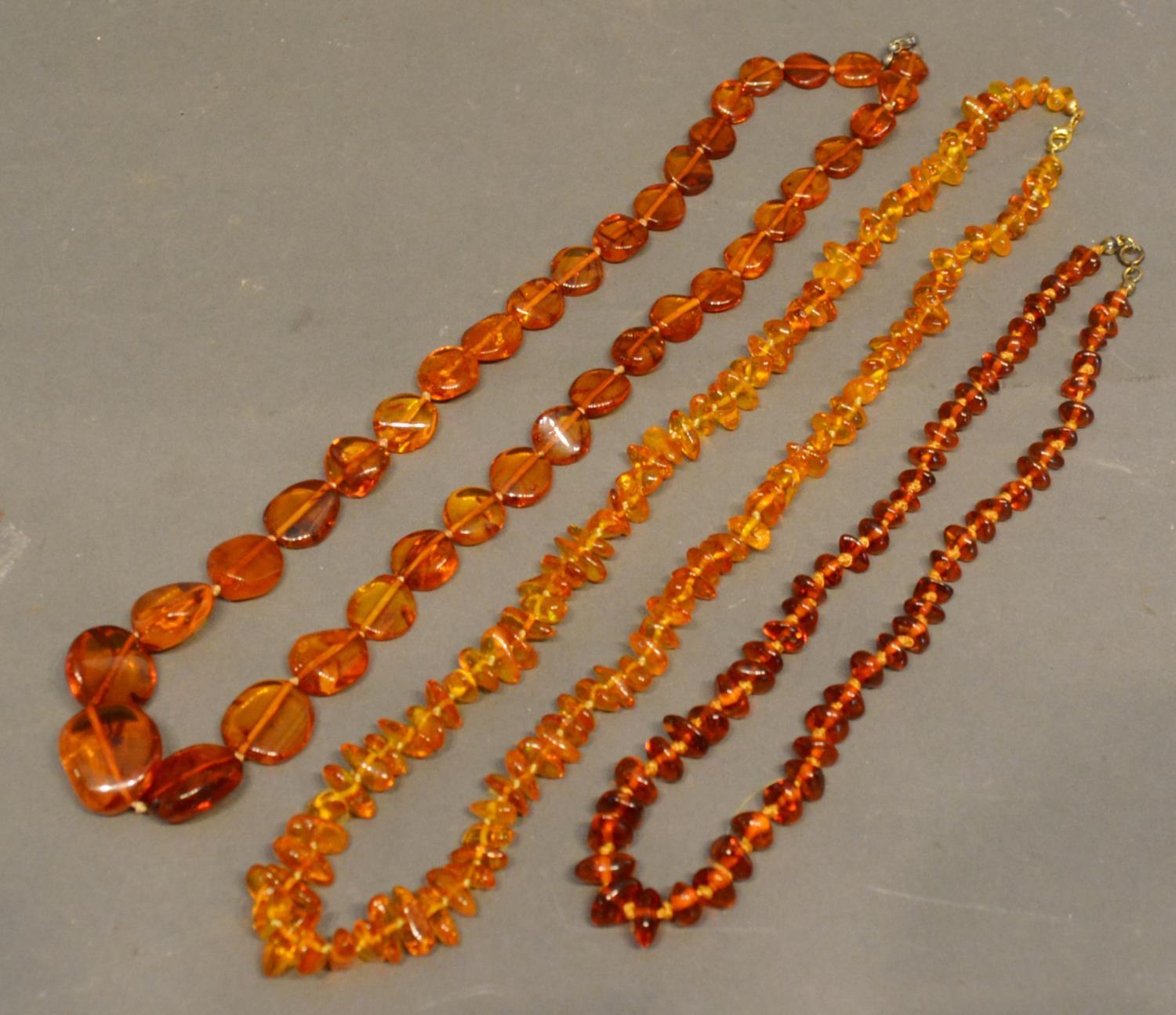 An Amber Bead Necklace, together with two other amber necklaces