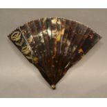 A Tortoiseshell Brise Fan, the guards with etched motifs, 16 cms long